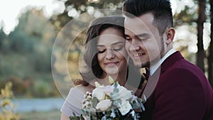Portrait of happy wedding couple stands in embraces of each other