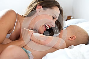 Portrait of a happy woman and baby laughing