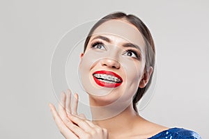 Portrait of happy woman with braces. Beautiful woman in braces smiling on white background