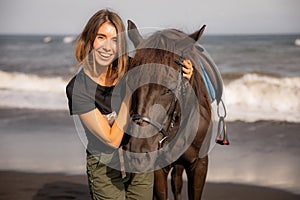 Portrait of happy woman and brown horse. Young Caucasian woman hugging horse. Romantic concept. Love to animals. Nature concept.