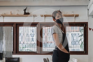 Portrait of happy woman cafe and restaurant owner with face mask.