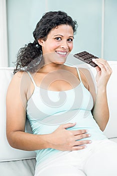 Portrait of happy woman with chocolate bar