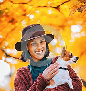 Portrait of happy woman dog outdoors in autumn