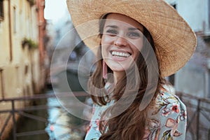 Portrait of happy woman in floral dress enjoying promenade