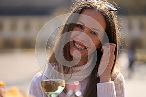 Portrait of happy woman with glass of wine