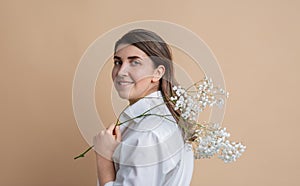 portrait of happy woman holding branch of flower
