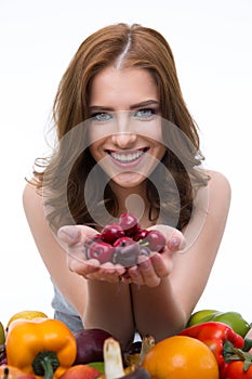 Portrait of a happy woman holding cherry