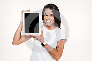 Portrait of a happy woman presenting blank screen tablet computer