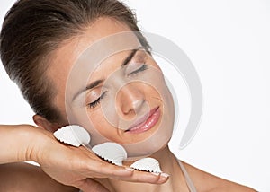 Portrait of happy woman with seashells