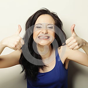 Portrait of happy woman showing thumbs up