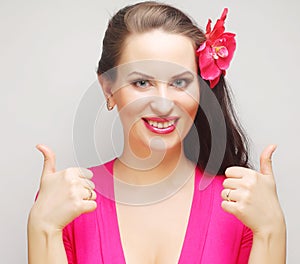 Portrait of happy woman showing thumbs up