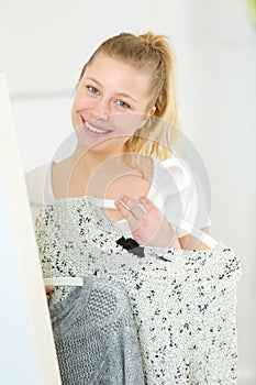 portrait happy woman tidying cloths