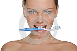 Portrait happy woman with toothbrush in teeth