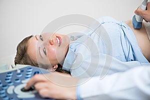 Portrait of happy woman at ultrasound examination