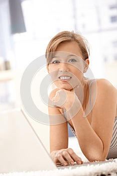 Portrait of happy woman using laptop computer