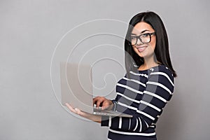 Portrait of a happy woman using laptop