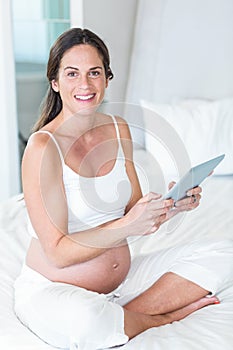 Portrait of happy woman using tablet pc