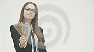 Portrait of happy woman wearing office clothing holding fan of money isolated over white background