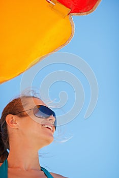 Portrait of happy woman on windy beach