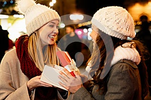 Portrait of happy women exchanging christmas presents. Holiday people christmas happiness concept