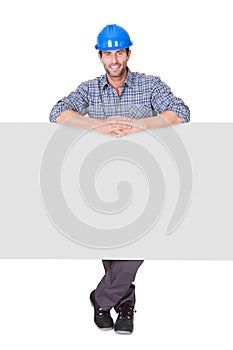 Portrait of happy worker presenting empty banner
