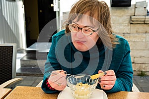 Portrait of a happy 40 yo woman with Down Syndrome eating an ice cream, Tienen, Belgium photo