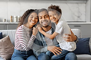 Portrait Of Happy Young African American Family Of Three With Little Son