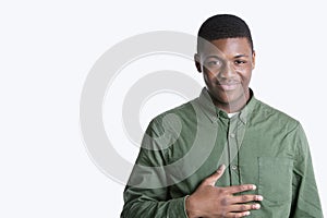 Portrait of a happy young African American man over gray background