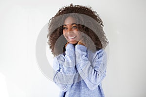 Portrait of happy young african woman laughing and looking away against white background