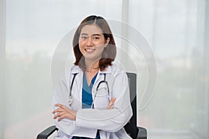 Portrait of happy young Asian female doctor