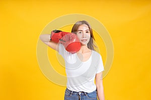 Portrait happy young asian woman with boxing glove  self business knock out