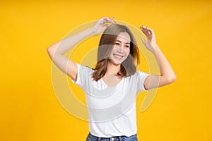 Portrait happy young asian woman dancing music celebrate fun enjoyment relaxation smiling positive emotion