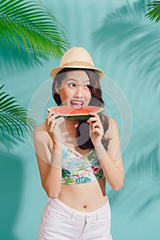 Portrait happy young asian woman is holding slice of watermelon