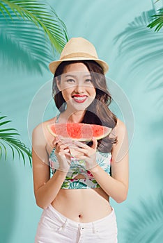 Portrait happy young asian woman is holding slice of watermelon
