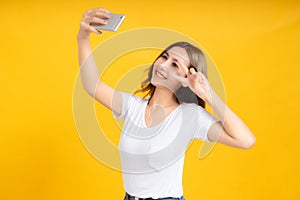 Portrait happy young asian woman laughing finger hands v-sign eye gesture selfie