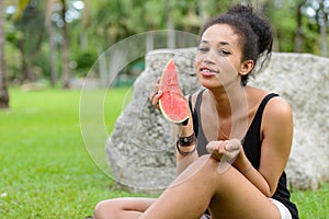 Portrait of happy young beautiful African woman at the park