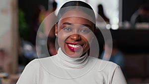 Portrait of happy young beautiful 20s gen-z black business woman with red lips smiling at camera at light trendy office. photo