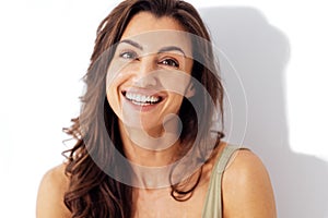 Portrait of happy young beautiful smiling woman. Studio shot of pretty caucasian brunette female on a white background