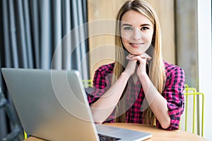 Portrait of happy young beauty woman using laptop at office table or cafe.