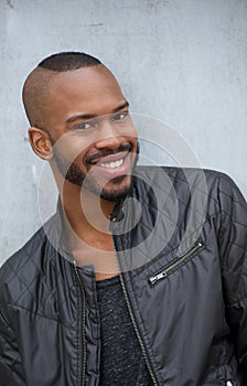 Portrait of a happy young black man smiling outdoors