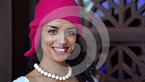 Portrait of happy young black woman, smiling broadly, dressed in ethnic headscarf