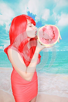 Portrait of happy young bright woman holding slice half of watermelon over colorful blue background