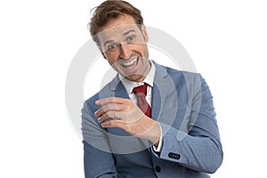 Portrait of happy young businessman in blue suit laughing