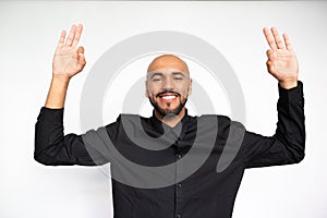 Portrait of happy young businessman showing ok gesture