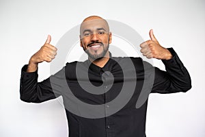 Portrait of happy young businessman showing thumbs up