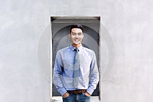 Portrait of Happy Young Businessman standing at Outside Building