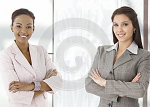 Portrait of happy young businesswomen in office