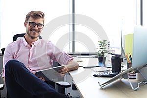 Portrait of a happy young casual businessman at office