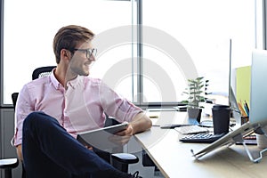 Portrait of a happy young casual businessman at office