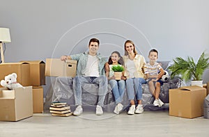 Portrait of happy young Caucasian family moving into their newly purchased house or apartment.